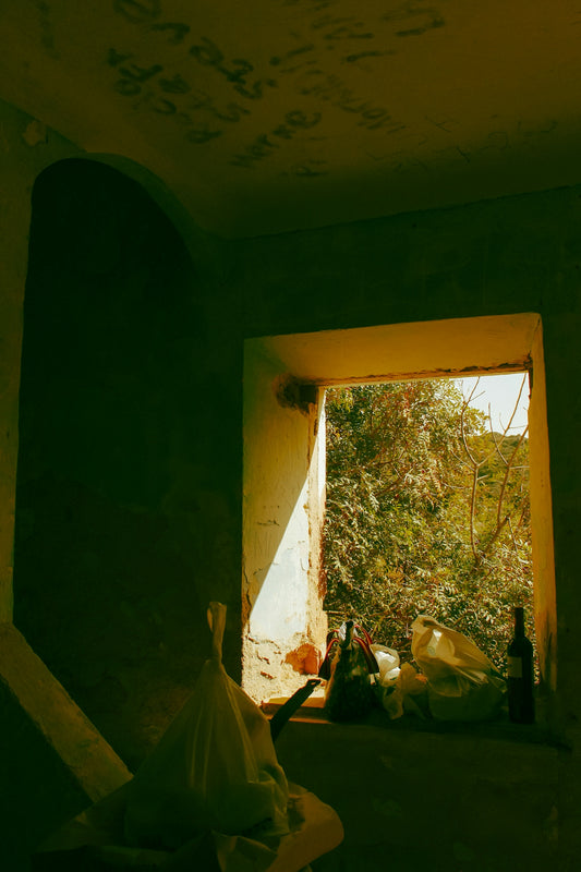 a room with a window and a trash bag