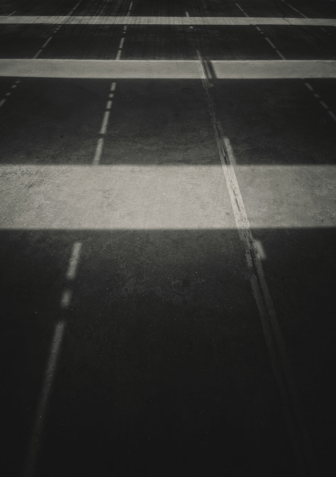 a black and white photo of an empty parking lot