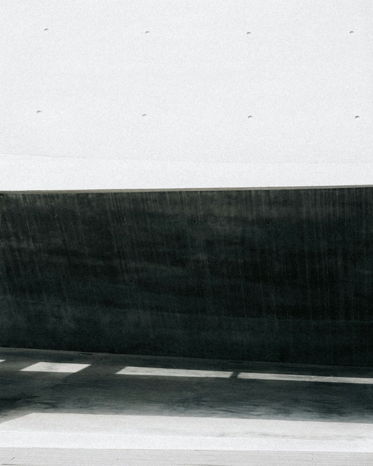 Dark shadows and white concrete create contrast.